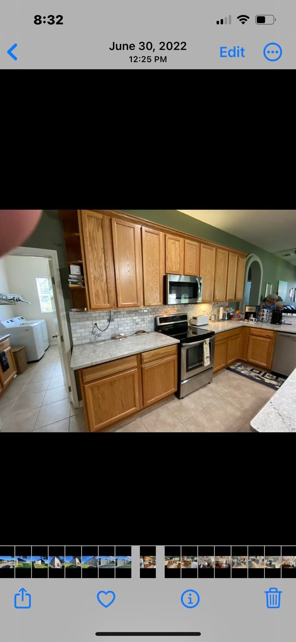 A kitchen with wood cabinets, stainless steel appliances, and a gray countertop.