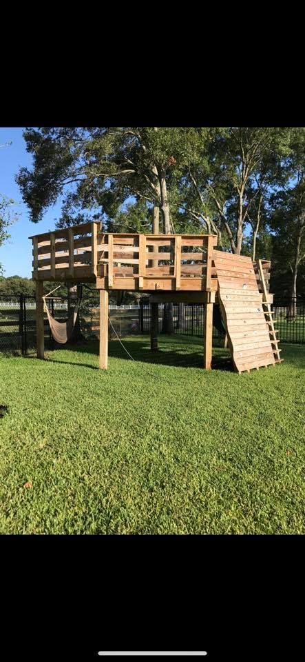 Staircase with black wrought iron railings, light wood handrails, and gray walls, protected by paper during renovations.