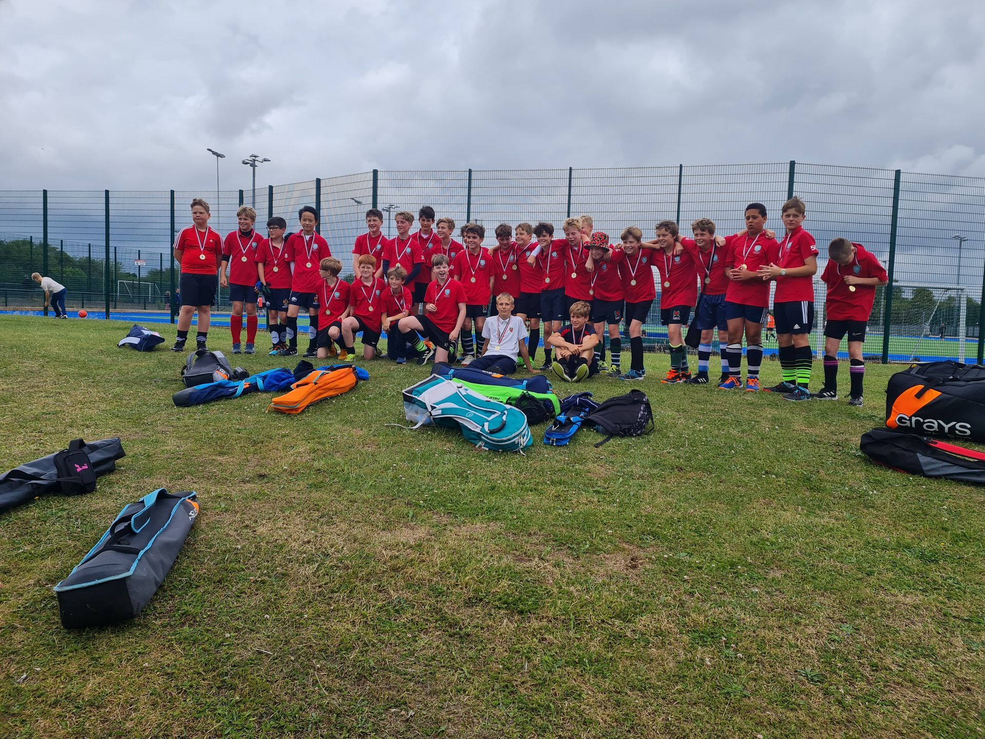 A group of soccer players are posing for a picture on a field.