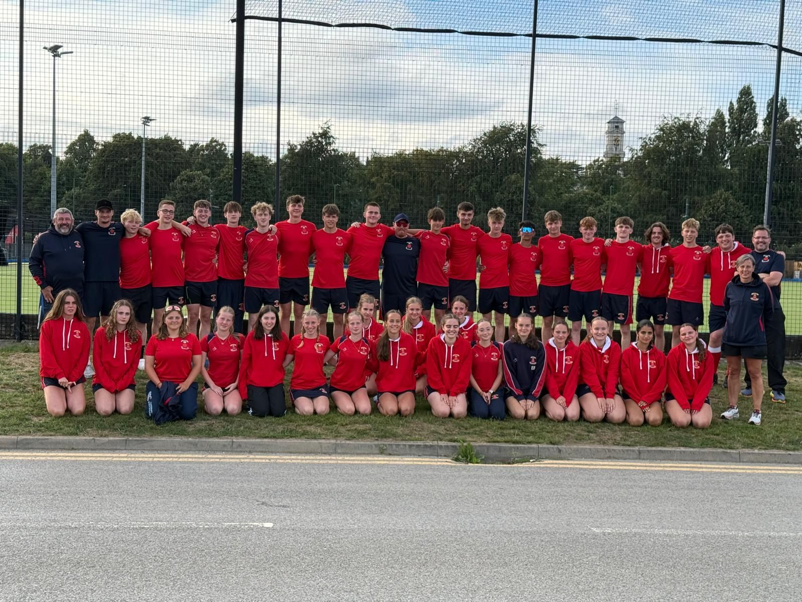 A group of young people are posing for a picture on a soccer field.