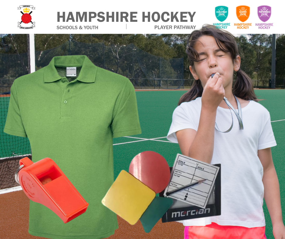 A girl blowing a whistle in front of a hampshire hockey logo