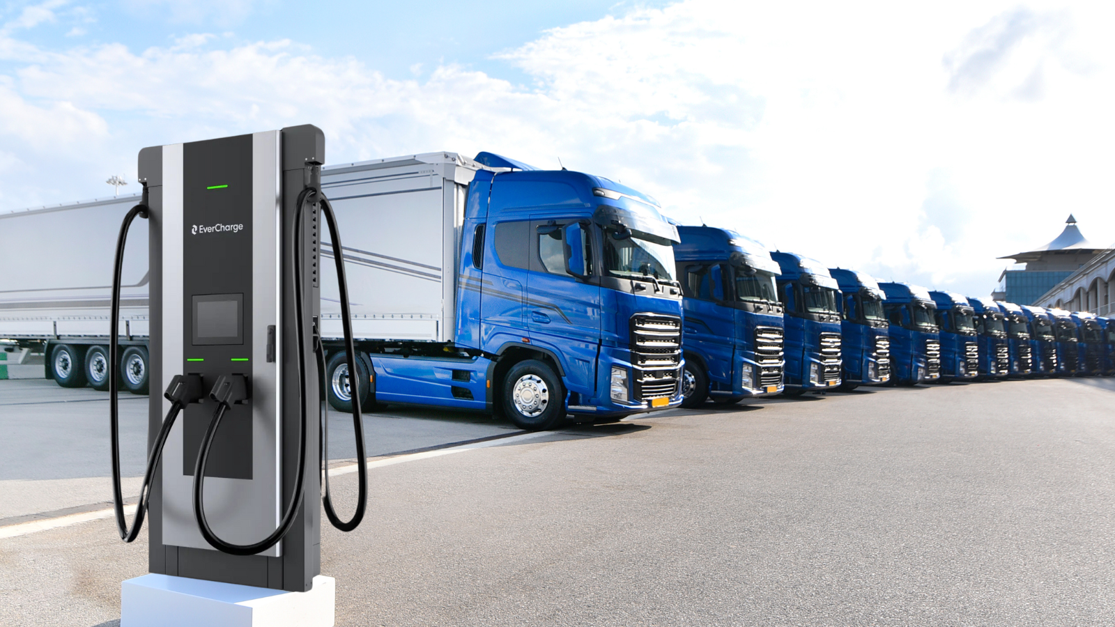 Electric truck charging station with blue semi-trucks parked in a row.