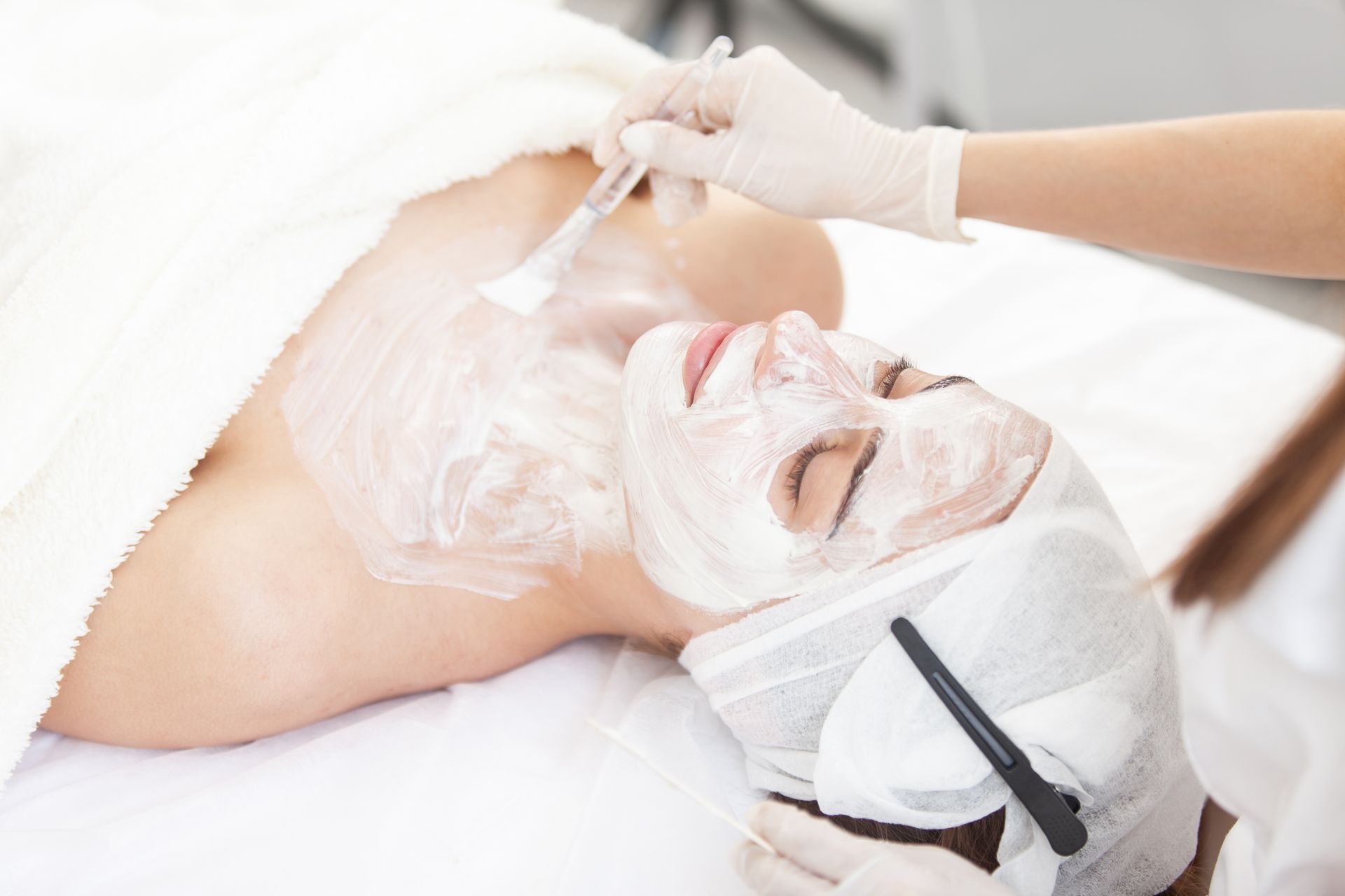 A woman is getting a facial treatment at a spa.