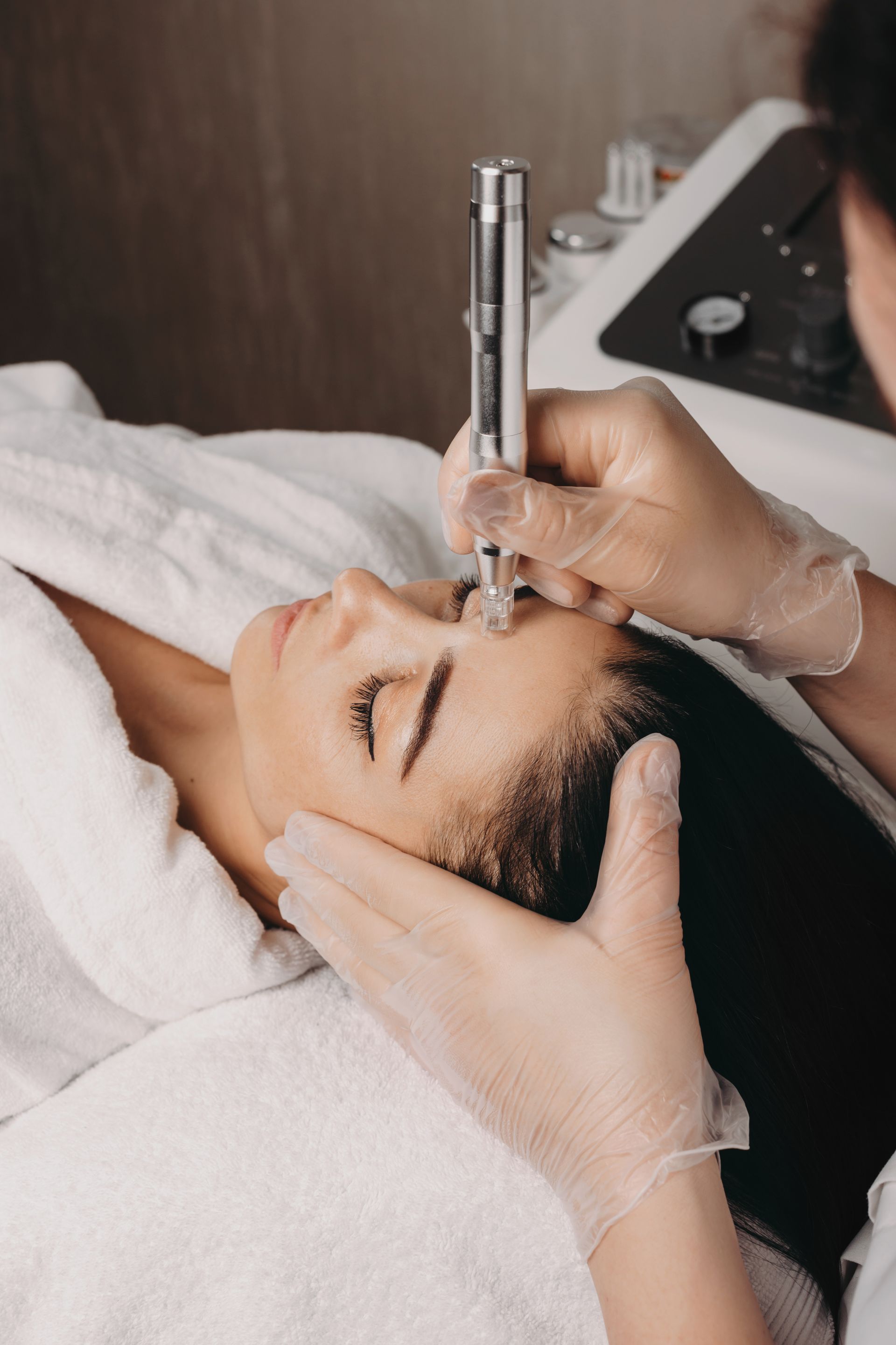 A woman is getting a facial treatment at a beauty salon.