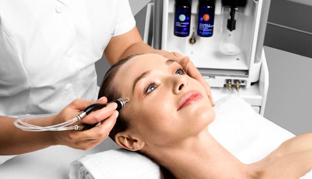 A woman is getting a facial treatment at a spa.