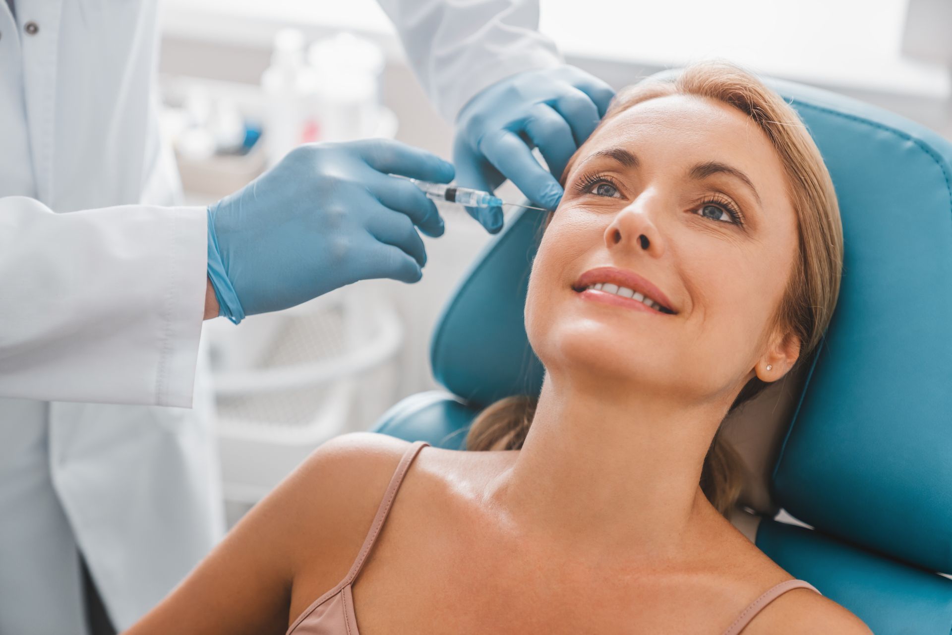 A woman is getting a Glutathione Injection in her face.