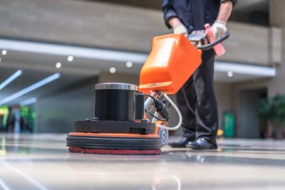 Floor Waxing — Janitor Using Floor Care Machine in Fayetteville, NC