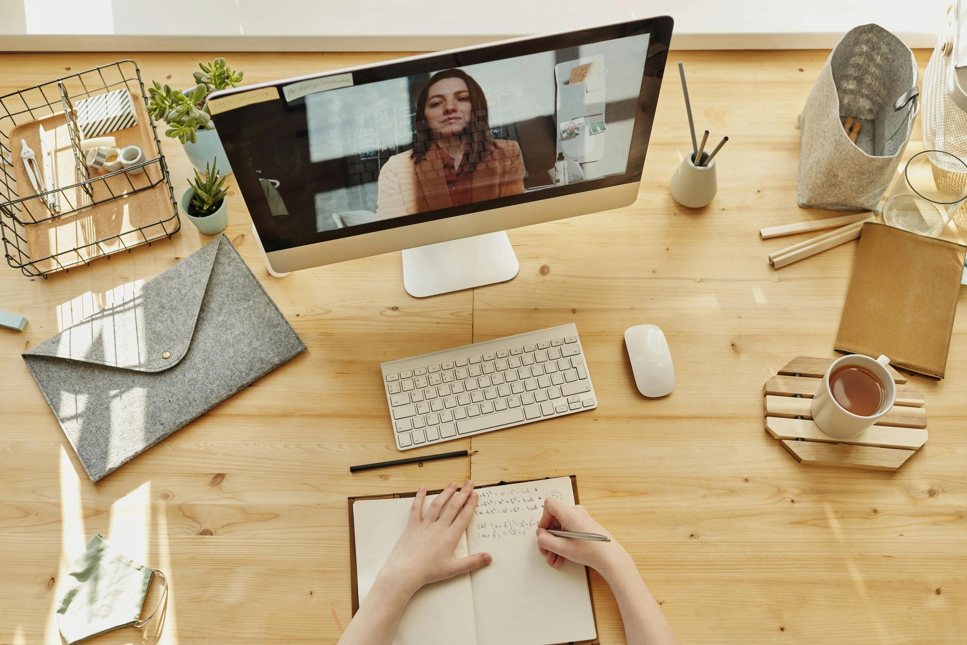 A woman is sitting at a table using a laptop computer.