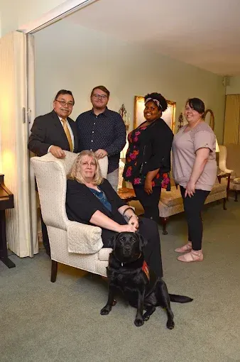 A group of people are posing for a picture together and smiling.