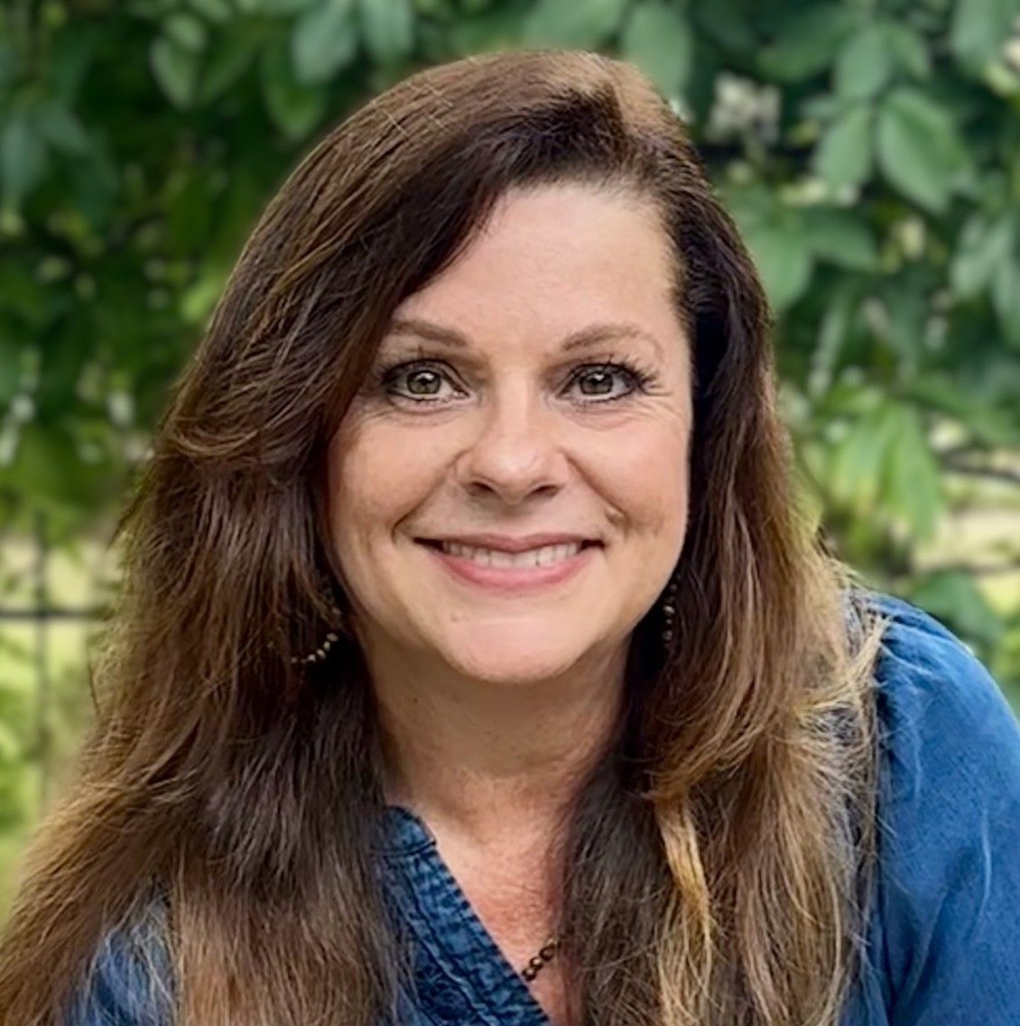 two girls are praying together over holy bible