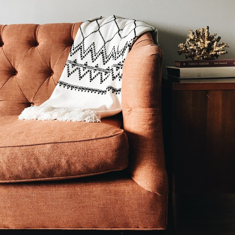 Brown sofa with white cloth