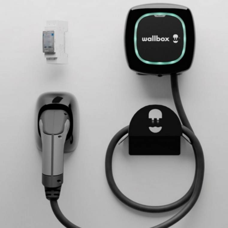 Two workers installing solar panels on a residential rooftop.