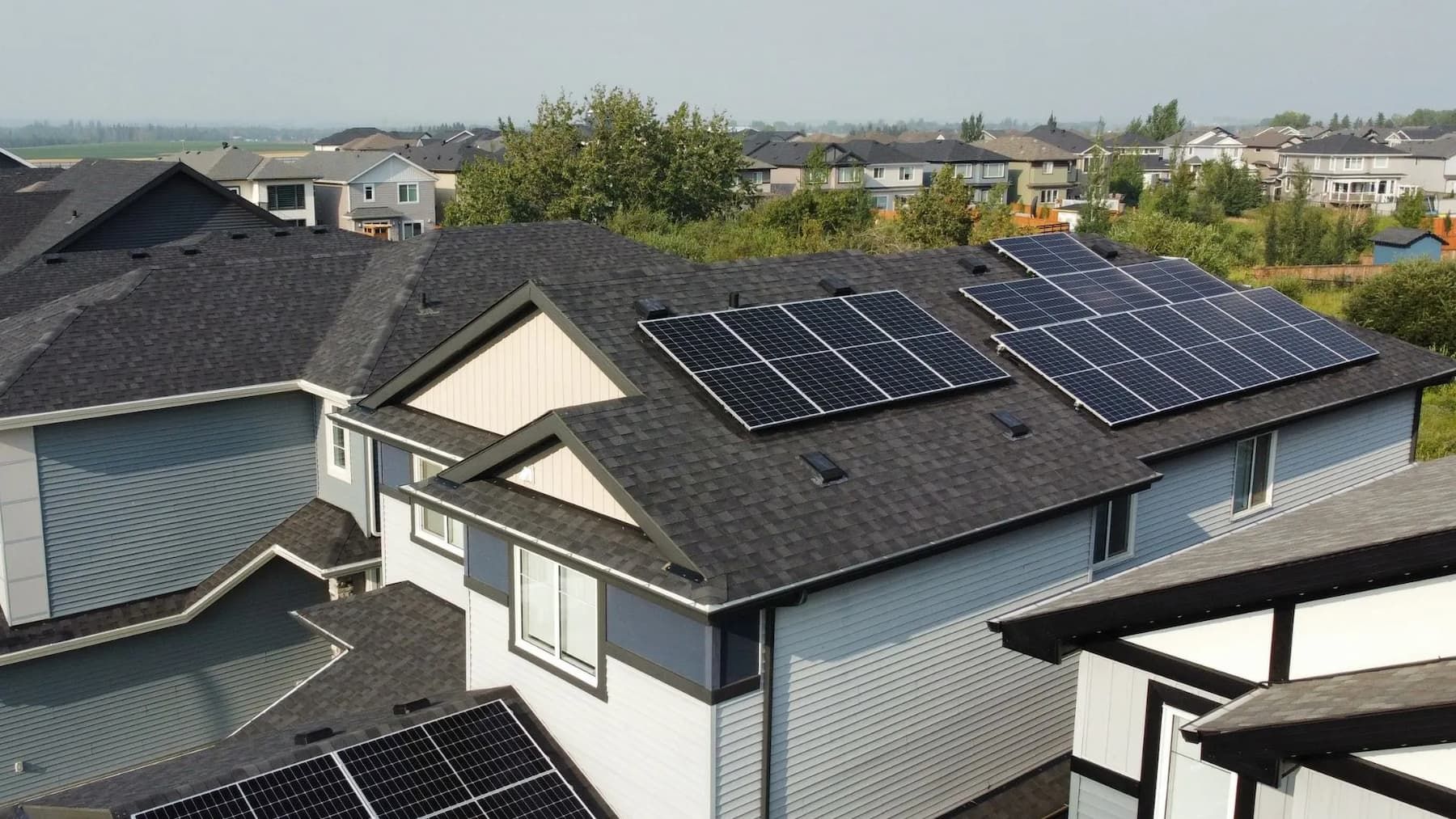 Solar panels on the roof of a house in a residential neighborhood.