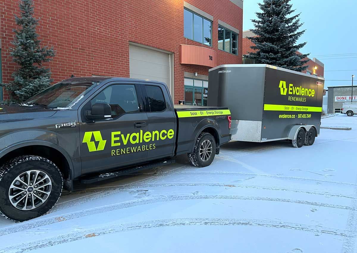 Commercial building with a dark roof and solar panels.