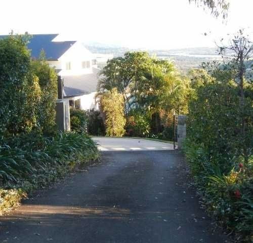 A Narrow road with a House in the Background — Roll Formed Driveways in Yandina, QLD
