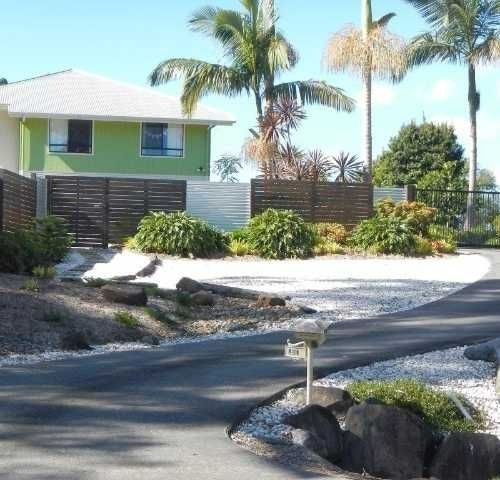 A House with Palm Trees and A Driveway — Roll Formed Driveways in Yandina, QLD