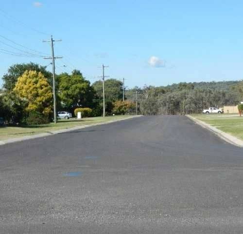 A Road with A Lot of Power Lines on It — Roll Formed Driveways in Yandina, QLD