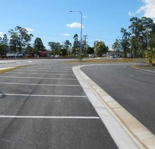 A Parking lot with a Street light in the Background — Roll Formed Driveways in Yandina, QLD