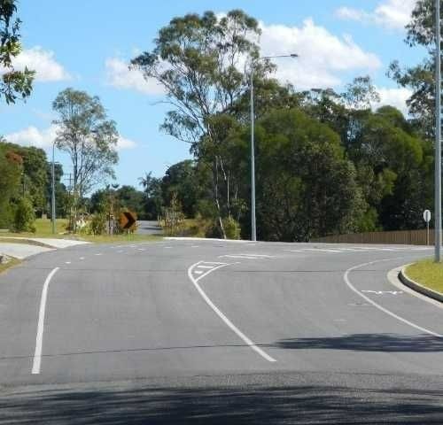 A Curvy Road with Trees on The Side of It — Roll Formed Driveways in Yandina, QLD