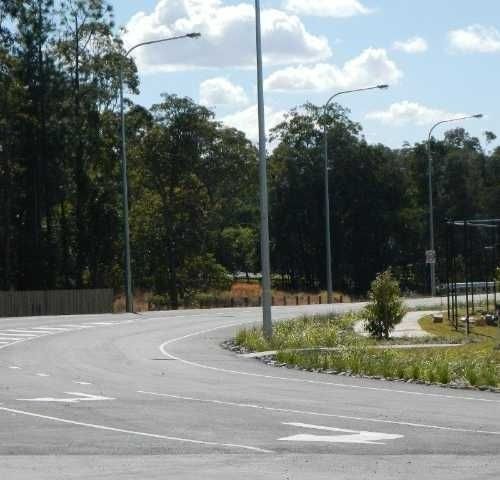 A Road with A White Arrow Pointing to The Right — Roll Formed Driveways in Yandina, QLD