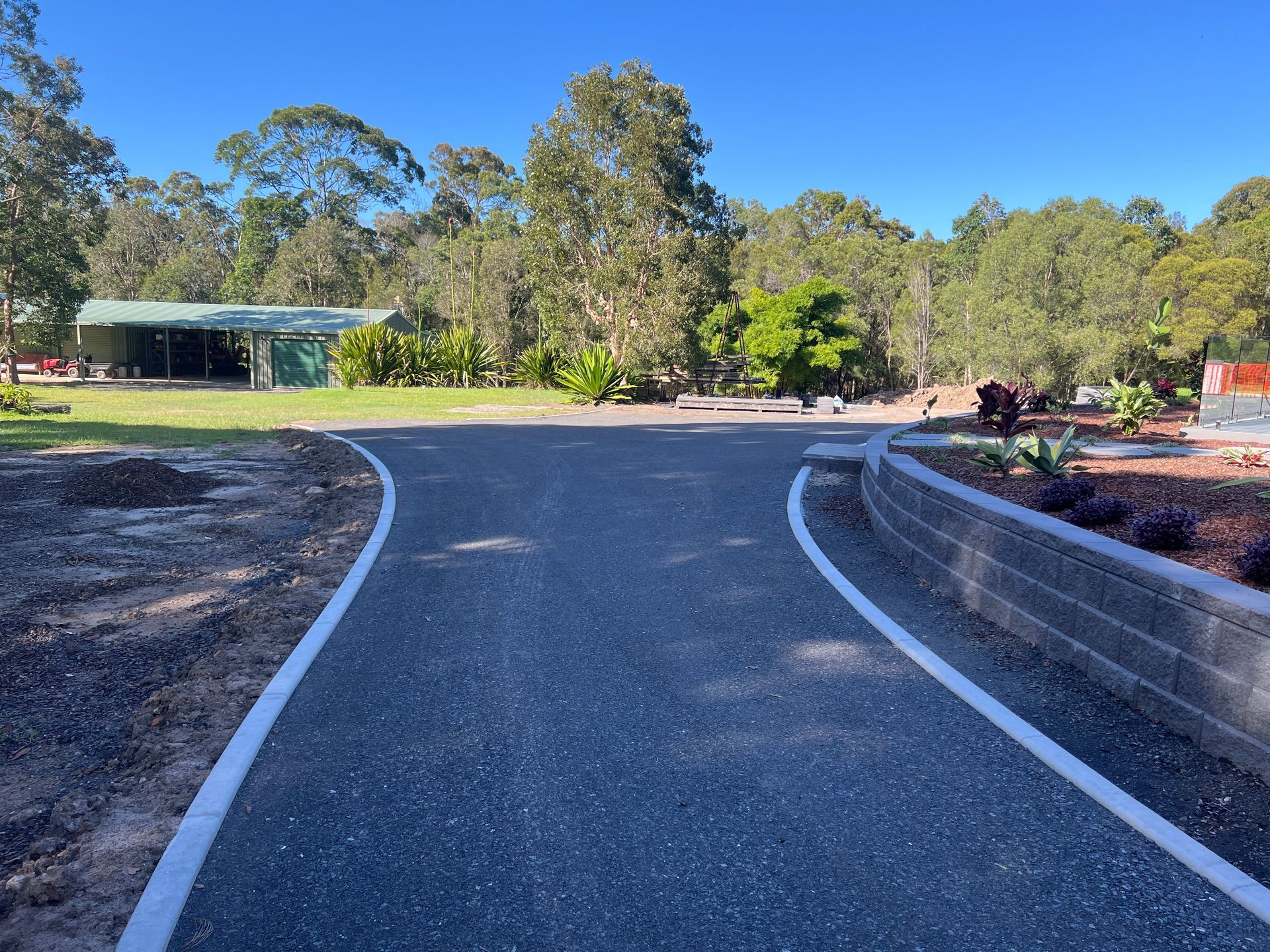 A Road With A White Line On The Side Of It — Roll Formed Driveways in Sunshine Coast, QLD