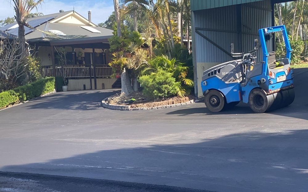 Blue Truck Parked on An Asphalt Driveway Near House