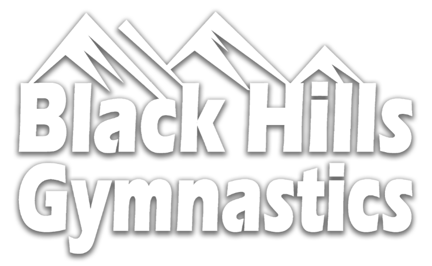 The logo for black hills gymnastics has a mountain in the background.