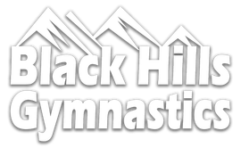 The logo for black hills gymnastics has a mountain in the background.