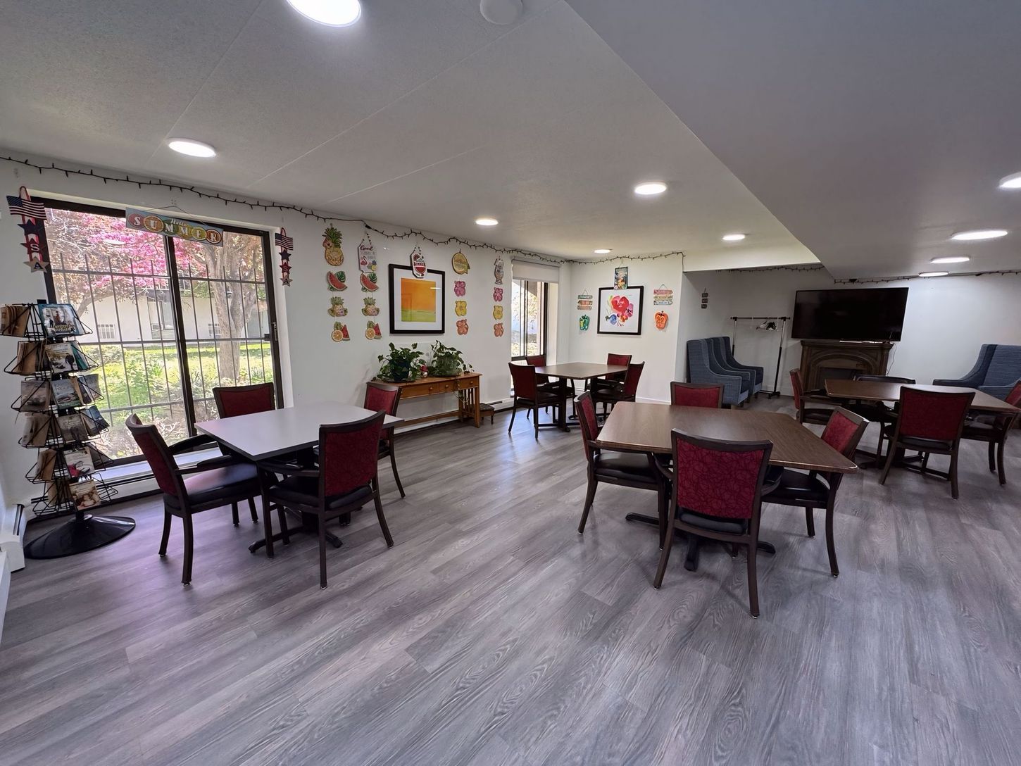 A large room with tables and chairs in it.