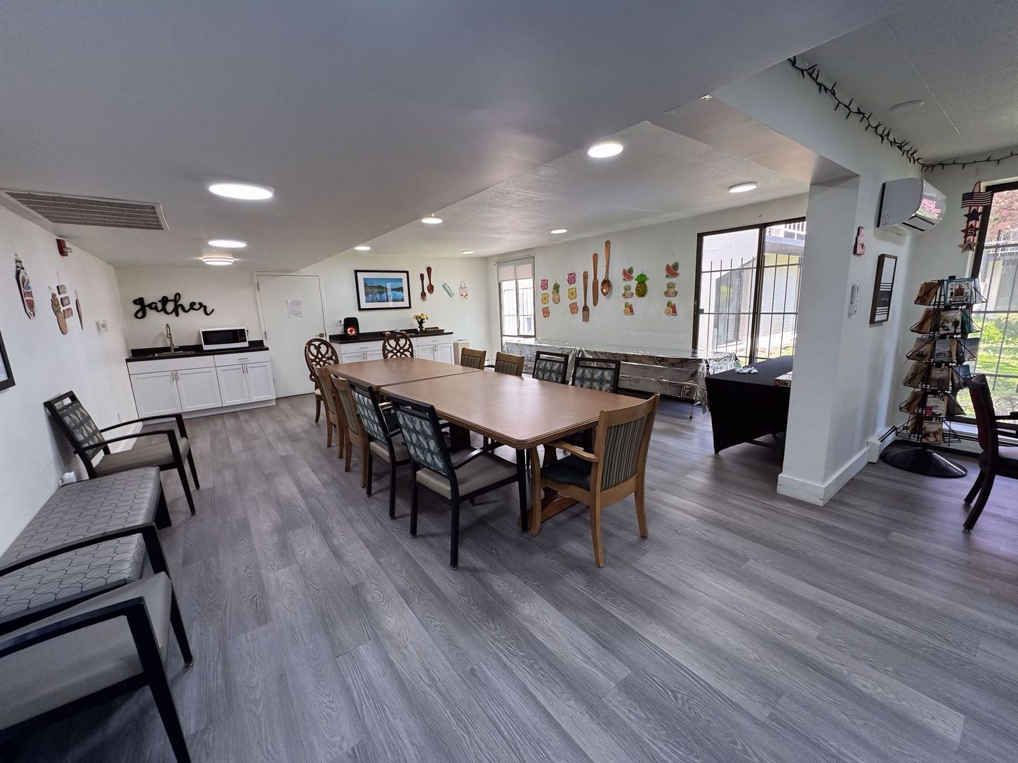 A large room with a long table and chairs in it.