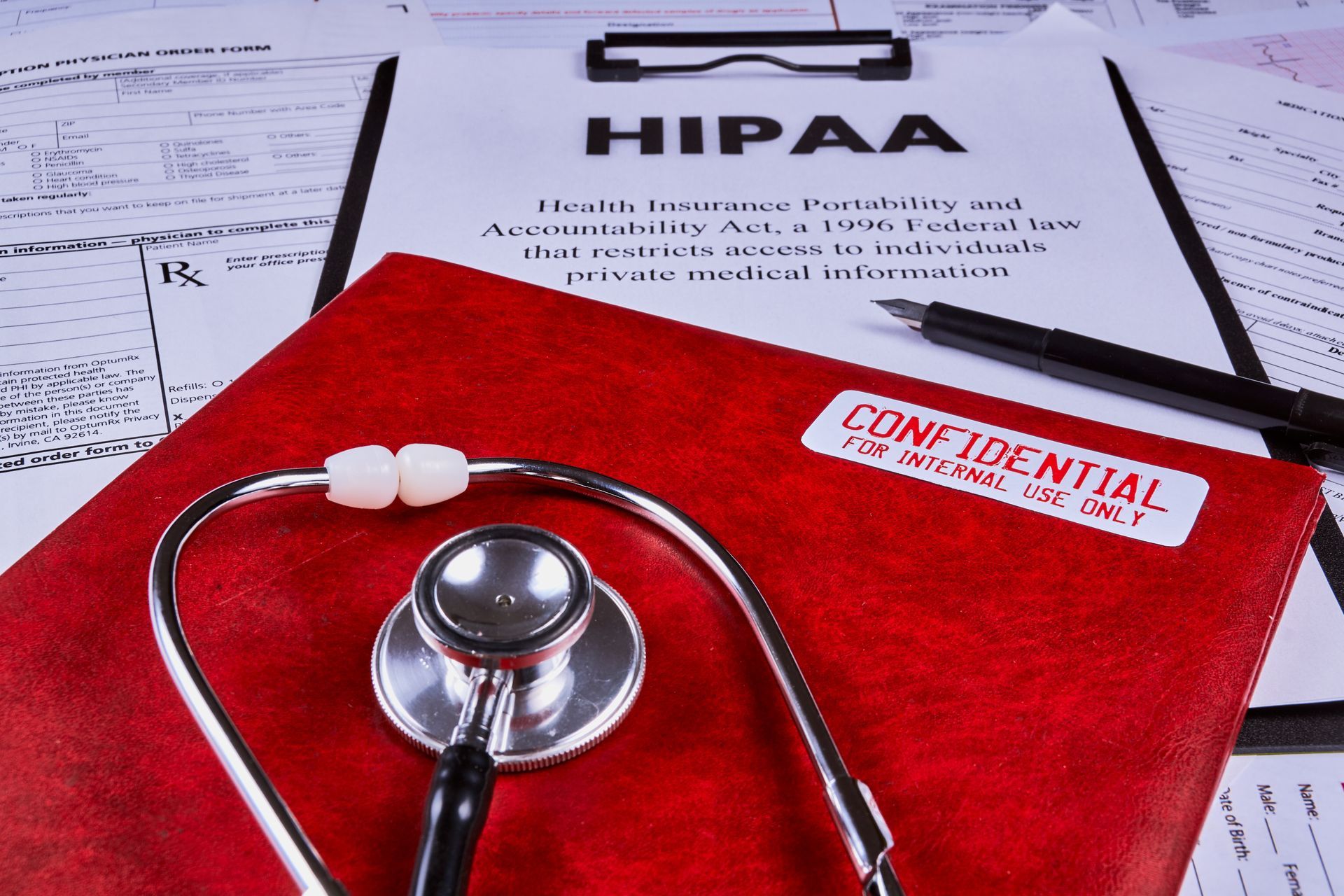 HIPAA document on a clipboard with a red folder marked 
