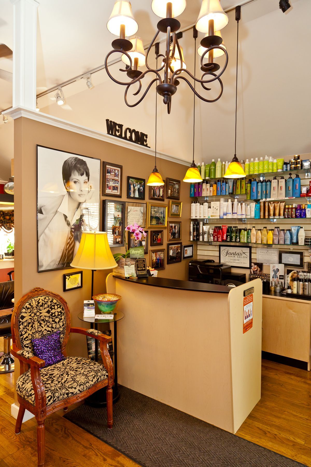 A salon with a chandelier and a sign that says welcome
