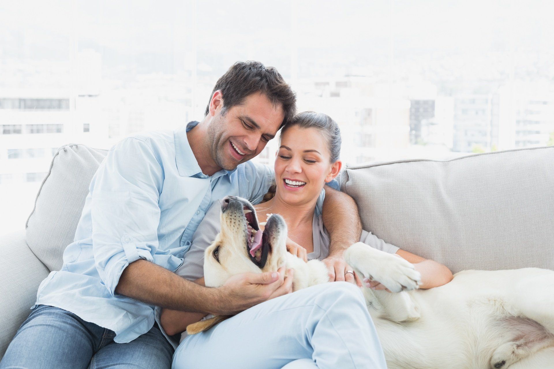 couple on couch with dog