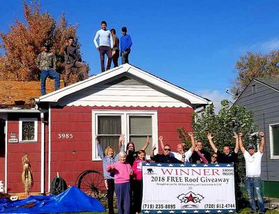 Industrial Roofing — Team Holding Winners 2018 Roof Giveaway Banner in Englewood, CO
