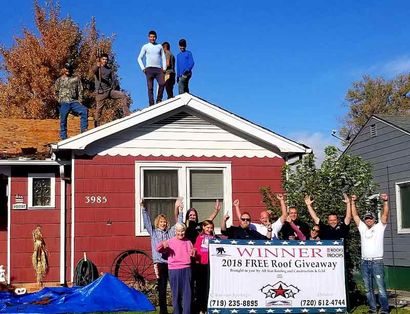 Industrial Roofing — Team Holding Winners 2018 Roof Giveaway Banner in Englewood, CO