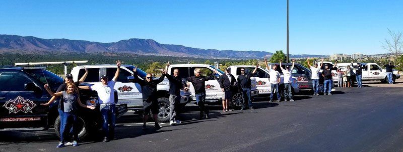 Industrial Roofing — All Star Roofing and Construction Team Raising Their Hands in Englewood, CO