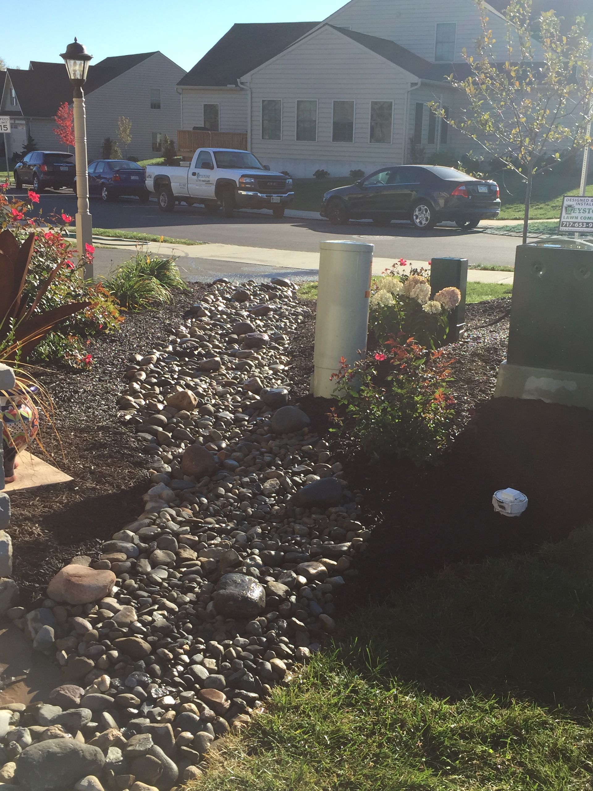A white truck is parked in front of a house