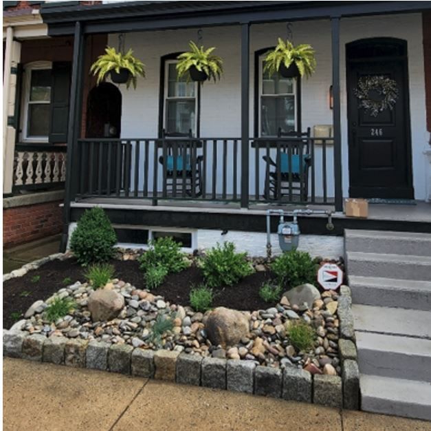 The front of a house with a porch and stairs