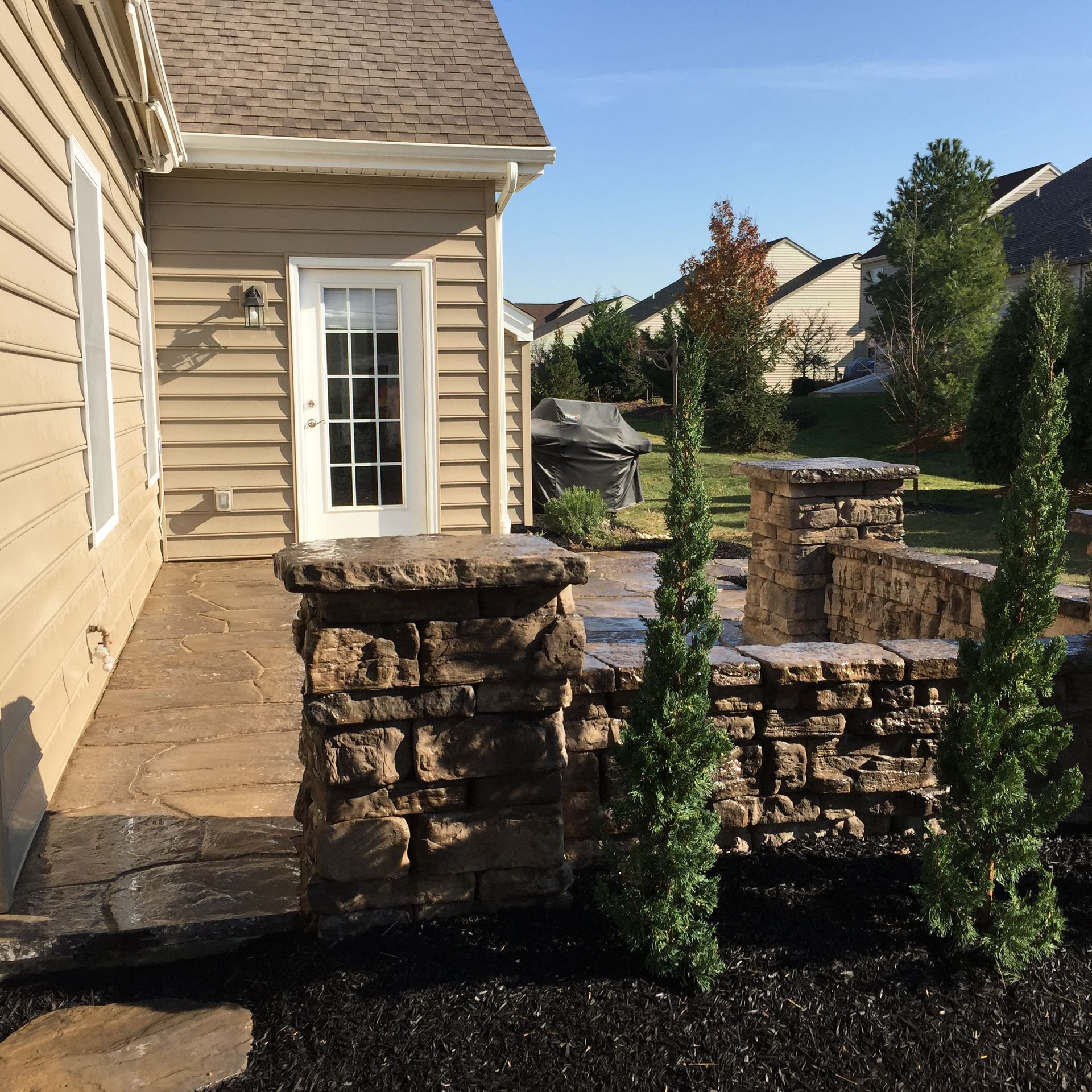 A house with a patio and a stone wall