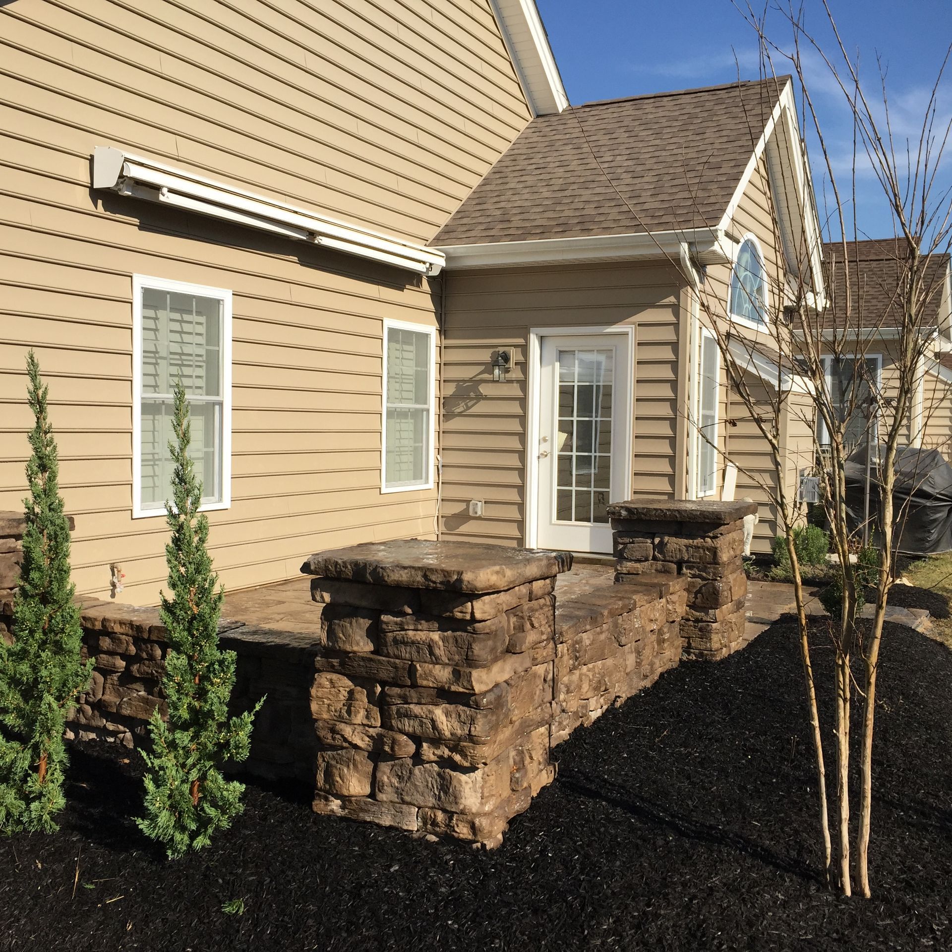 A house with a stone walkway leading to the front door