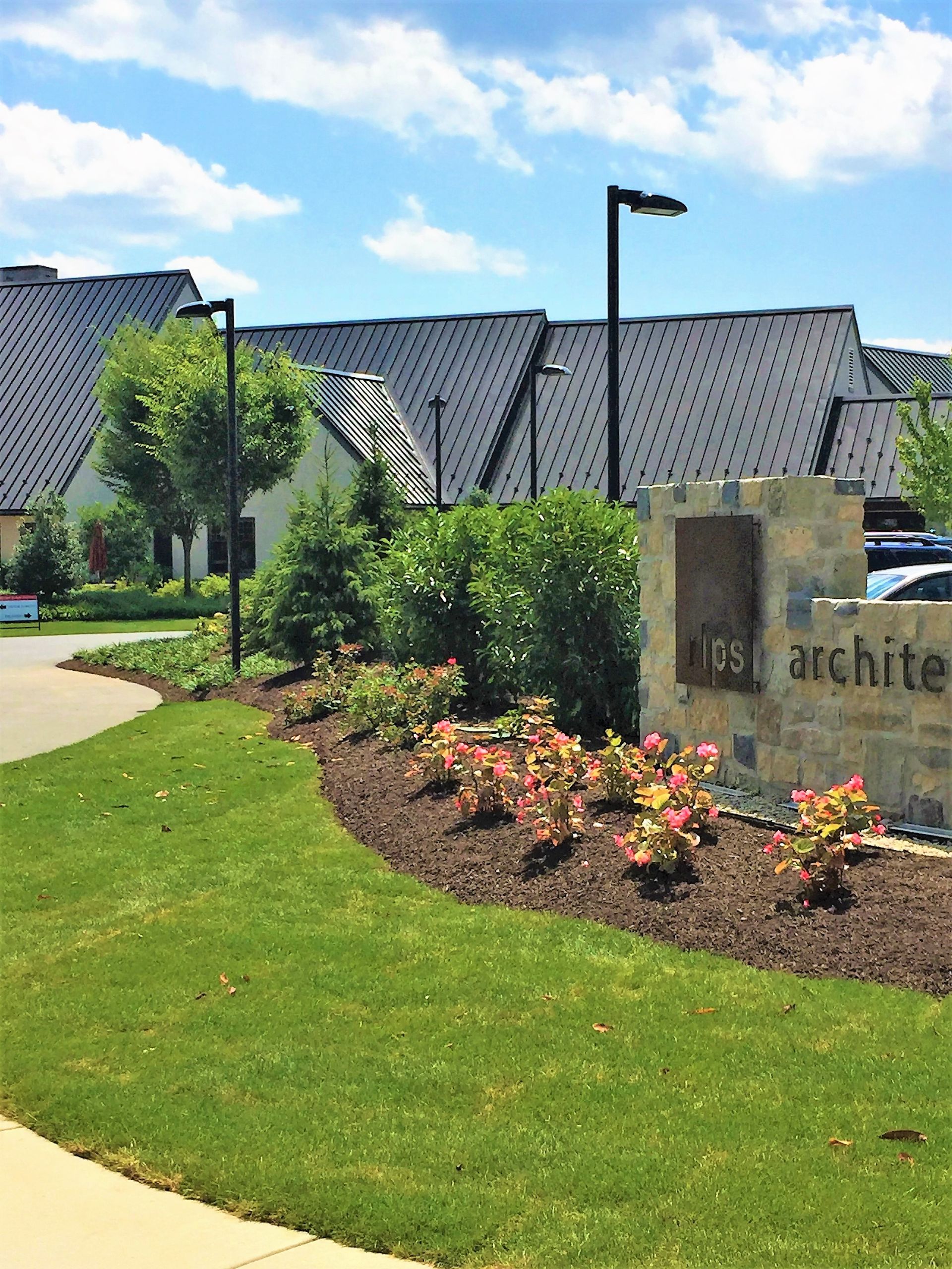 A large building with a sign in front of it that says archite