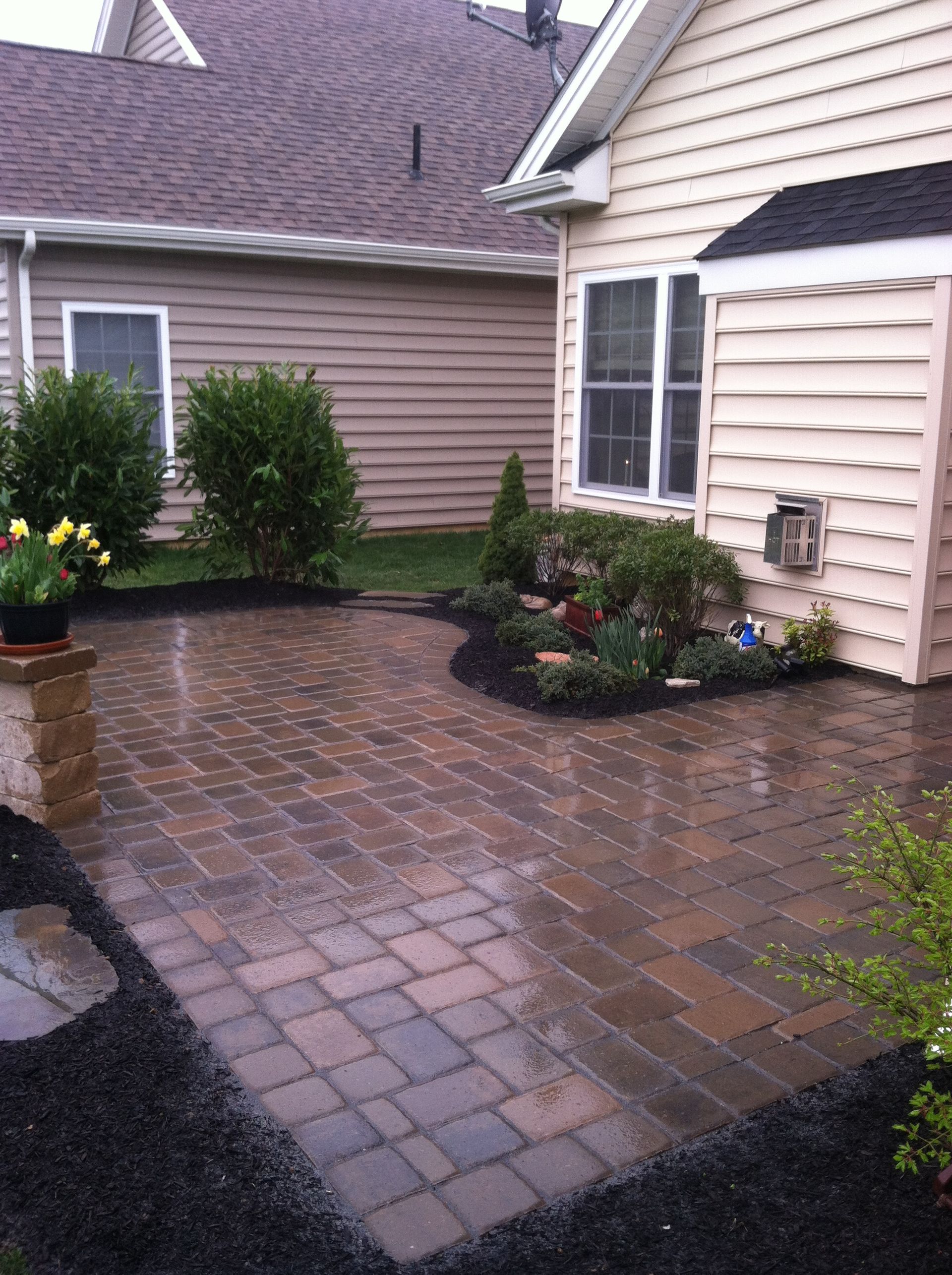 A house with a brick patio in front of it