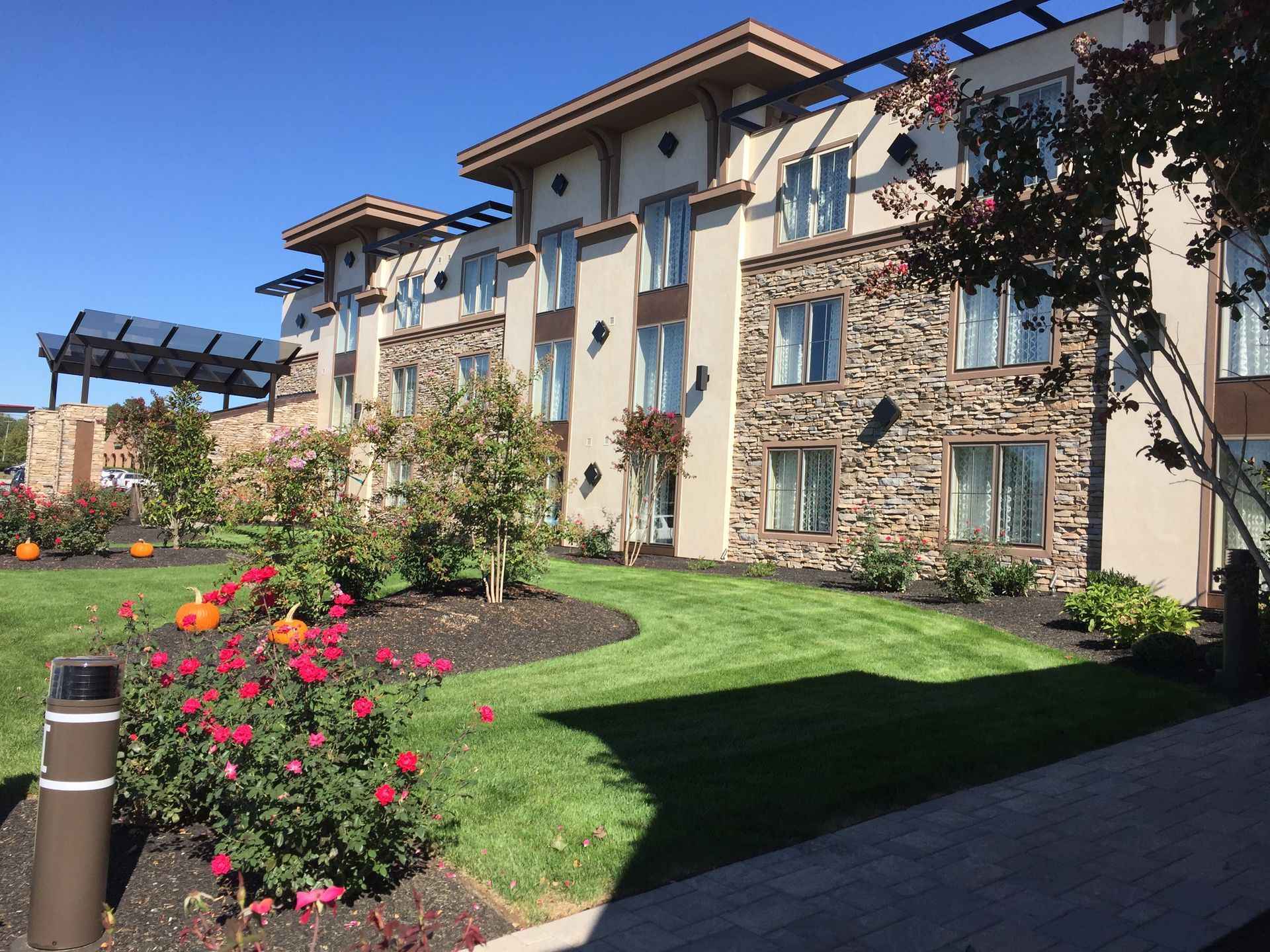 A large building with a lush green lawn in front of it