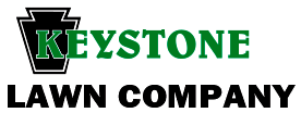 The logo for keystone lawn company is green and black