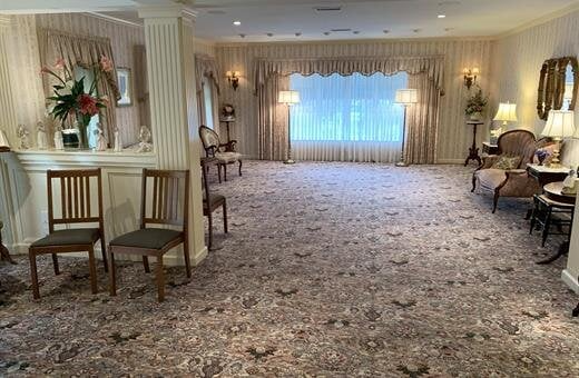 A large room with a lot of furniture and a large window.