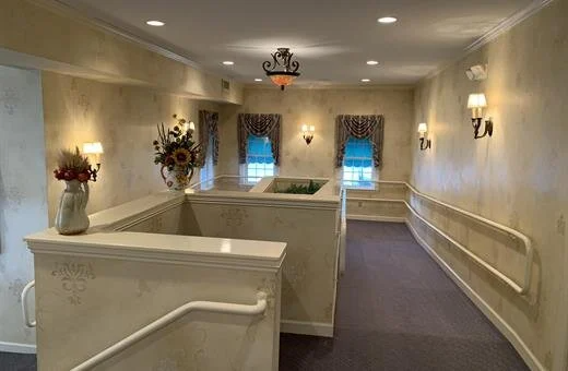 A long hallway with a vase of flowers in the middle