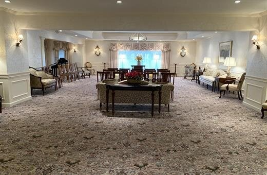 A large room with a table and chairs in it.