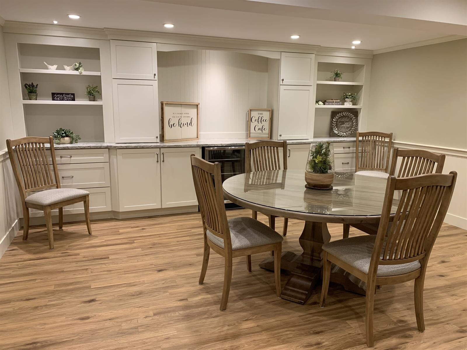A dining room with a table and chairs in a basement.