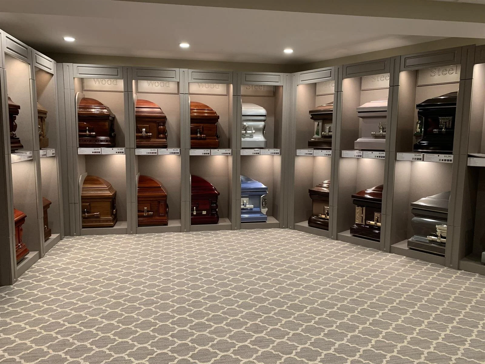 A room filled with lots of coffins on display.