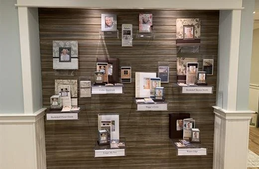 A wall with a lot of pictures and candles on it.